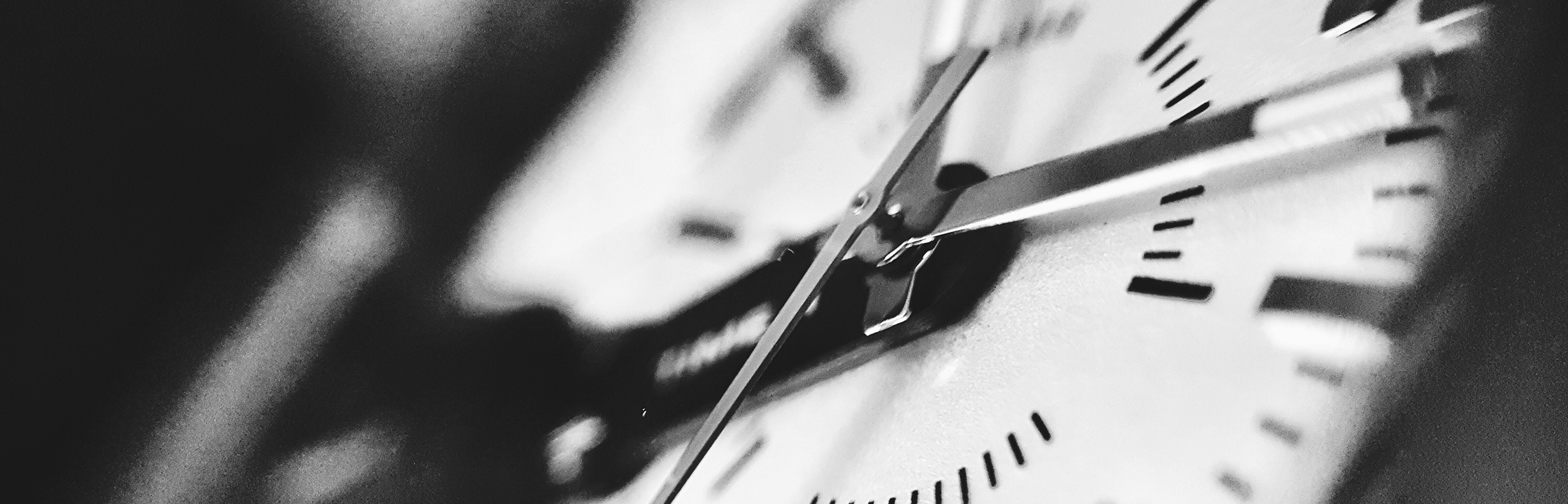 Black and white close up of an analog wall clock
